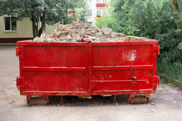 red container with solid domestic and construction waste.
